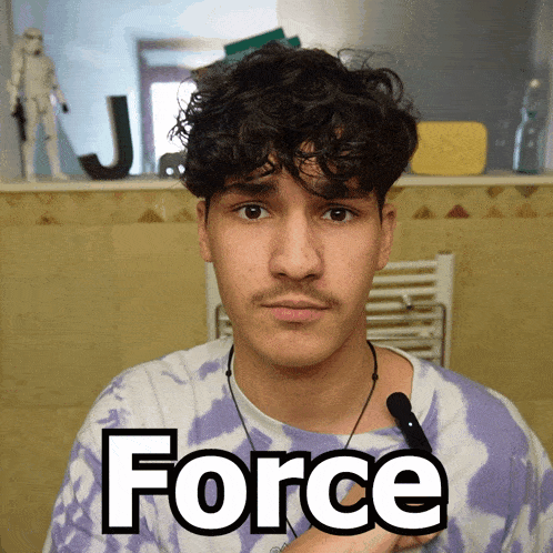 a man wearing a purple tie dye shirt has the word force written on his chest