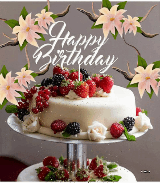 a birthday cake with strawberries and blackberries on it and the words happy birthday