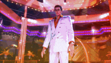 a man in a white suit is standing in front of a stage with purple lights