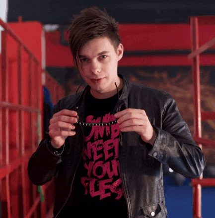 a young man wearing a t-shirt that says ' i need your flesh '