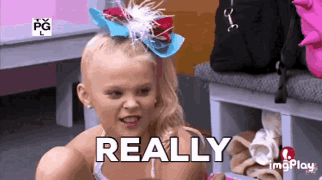 a little girl with a bow in her hair has the word really written on her face