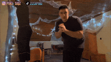 two men are standing in a room with the hashtag 223piki on the bottom left