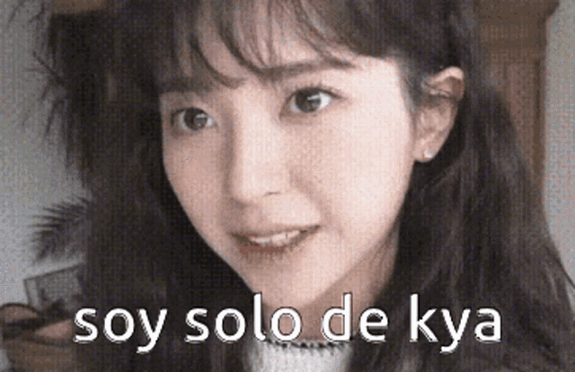 a close up of a woman 's face with the words soy solo de kya written on it