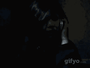 a woman is screaming while talking on a cell phone with a gifyo.com logo in the background