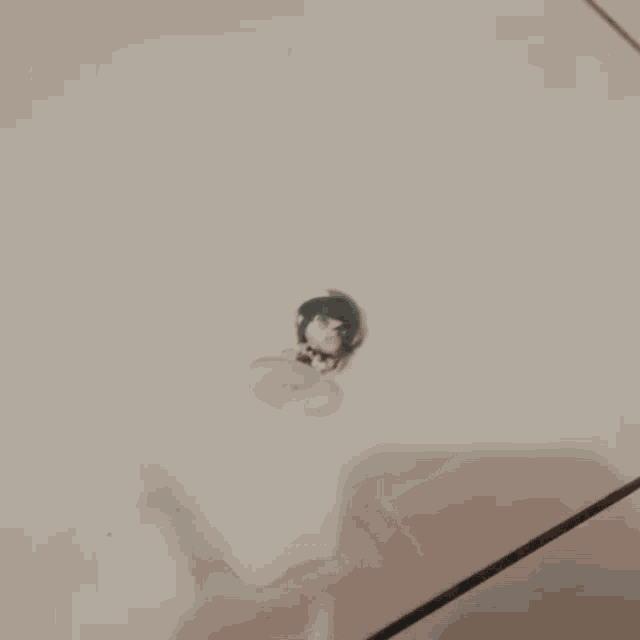 a blurry picture of a person wearing a hat and glasses .