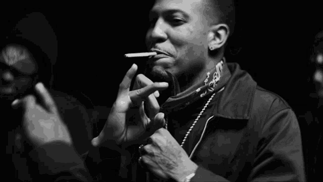 a man wearing a bandana smoking a cigarette