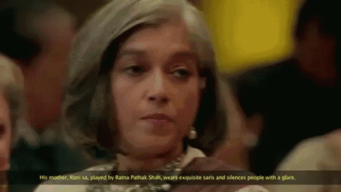 a woman with gray hair is sitting in a crowd with a caption that says " his mother rani sa "