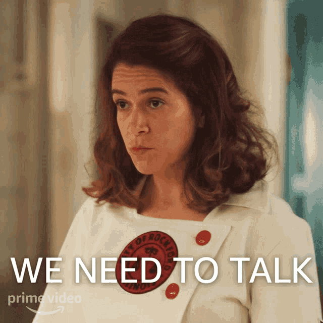 a woman is wearing a white shirt with red buttons and the words we need to talk on the bottom