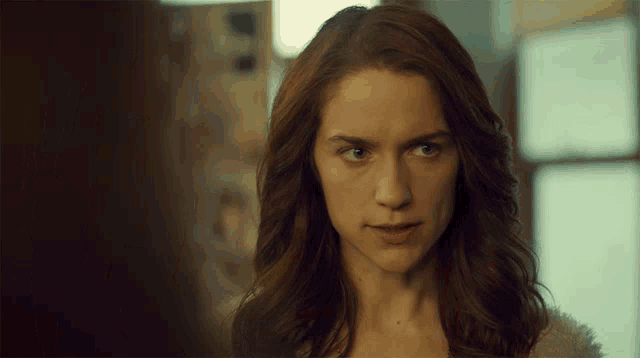 a close up of a woman 's face with a blurred background