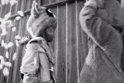 a black and white photo of two people standing next to each other .