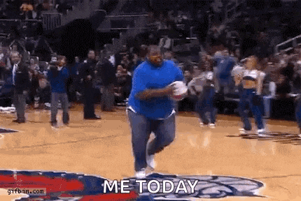 a man in a blue shirt is running on a basketball court with the words `` me today '' written on the ground .