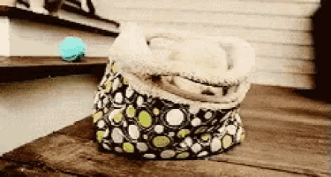 a polka dot blanket is sitting on a wooden table