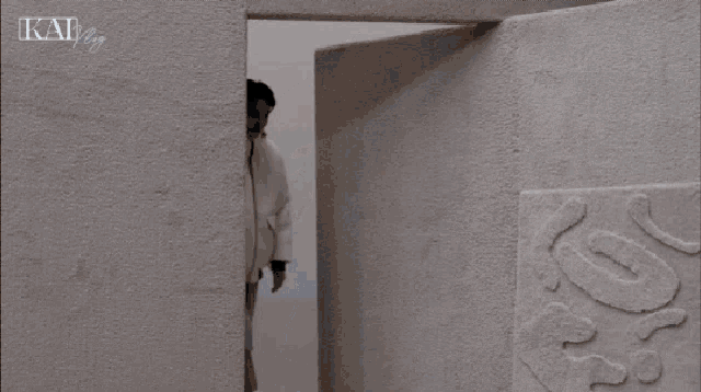 a man wearing a white jacket with the word kai written on the bottom