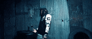a man wearing a black and white jacket with the letter c on it