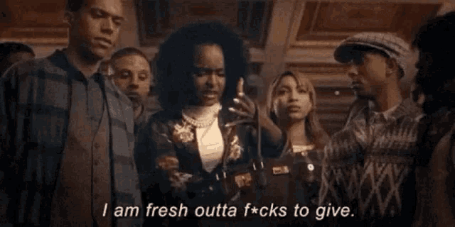 a group of people are standing in a room and one of them is saying i am fresh outta f * cks to give
