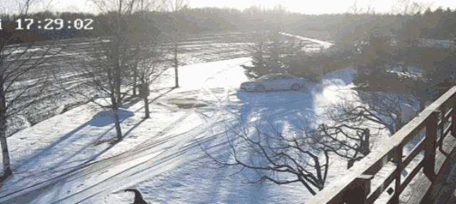 a car is driving down a snowy road and the time reads 17:29