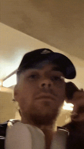 a man wearing a hat and headphones is looking at something