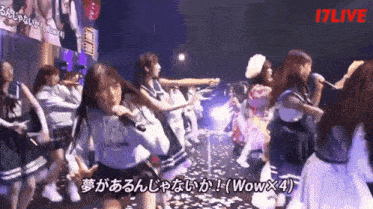 a group of girls are dancing in front of a sign that says i7live