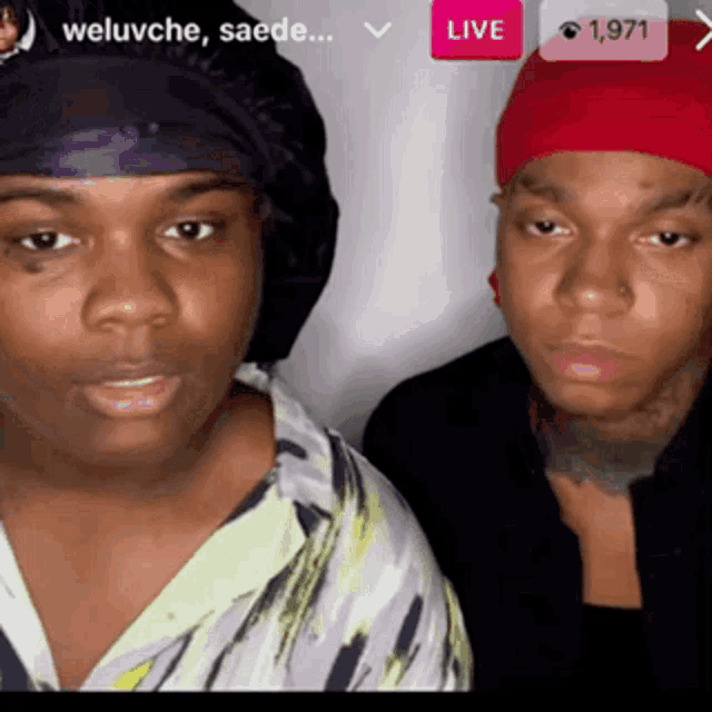 two people are standing next to each other in front of a screen that says live on it
