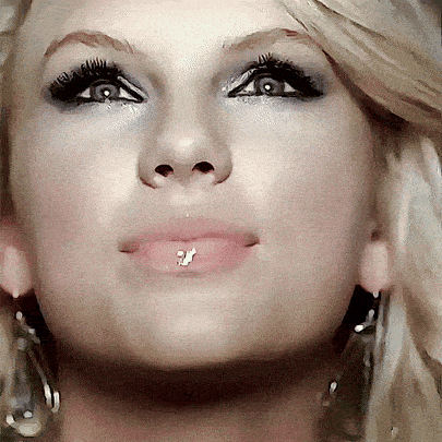 a close up of a woman 's face with a lip ring