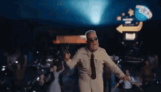 a man in a military uniform and tie is dancing in a dark room .