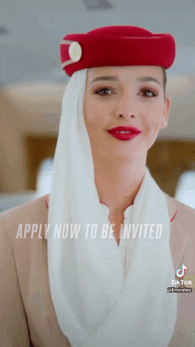 a woman wearing a red hat and a white scarf with the words apply now to be invited