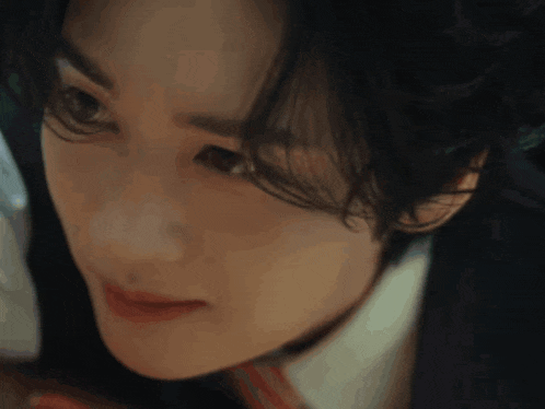 a close up of a woman 's face with a serious look on her face