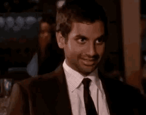a man in a suit and tie is smiling and saying bom dia pai !