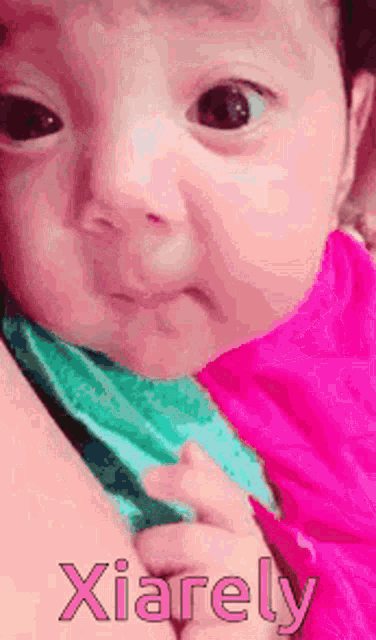 a baby is being held in someone 's arms and the baby 's name is xiarely .
