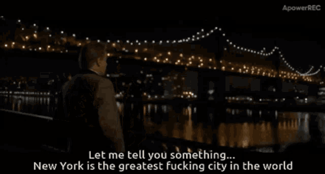 a man in a suit is standing in front of a bridge and says let me tell you something new york is the greatest fucking city
