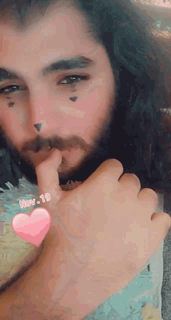a man with a beard has a pink heart on his wrist and the date november 19
