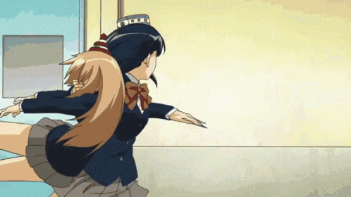 a girl in a school uniform is kicking another girl in the butt
