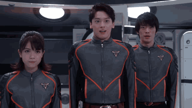 a man and a woman are standing next to each other wearing uniforms