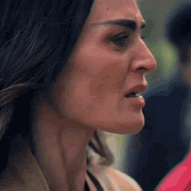 a close up of a woman 's face with a serious expression