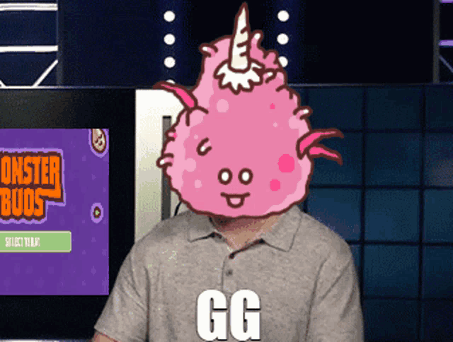 a man with a monster buds game on the screen behind him