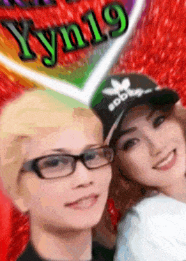 a man and a woman are posing for a picture and the man is wearing glasses