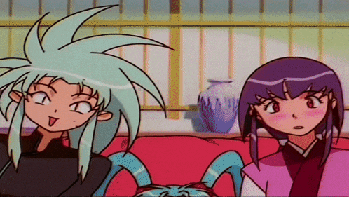 a couple of anime characters sitting on a couch with a vase in the background