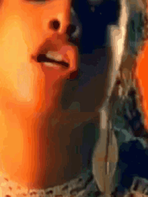 a close up of a woman 's face with a blurred background