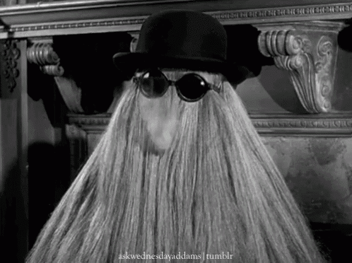 a person with a beard wearing sunglasses and a hat with the words askwednesdayaddams tumblr below it