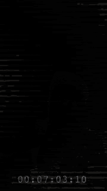 a black and white photo with the time 00 : 07 : 04 : 01 on the bottom