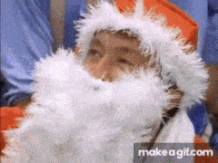 a child is dressed as santa claus and has a white beard