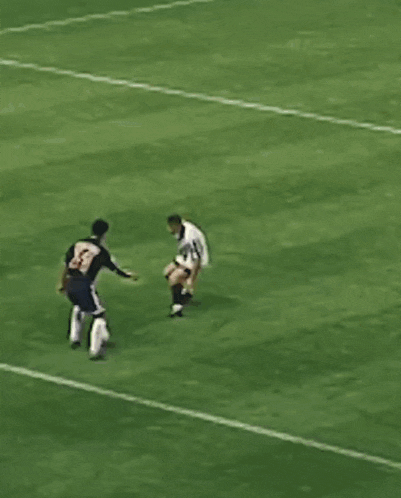 a soccer player with the number 1 on his shorts is kicking the ball