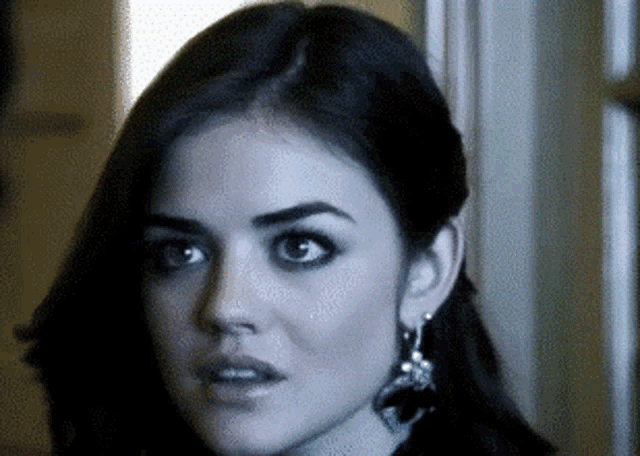 a close up of a woman 's face with earrings