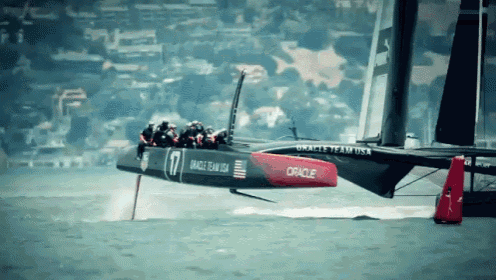 an oracle team usa sailboat is flying over the ocean
