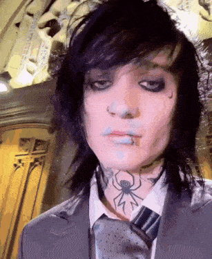 a man with a spider tattoo on his neck