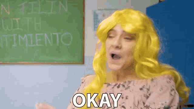 a woman in a yellow wig is saying okay