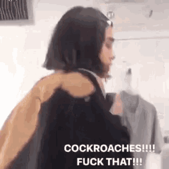 a woman is holding a man 's shoulder and says cockroaches !!! fuck that !!!