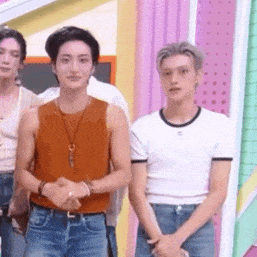 a group of young men are standing next to each other on a stage .