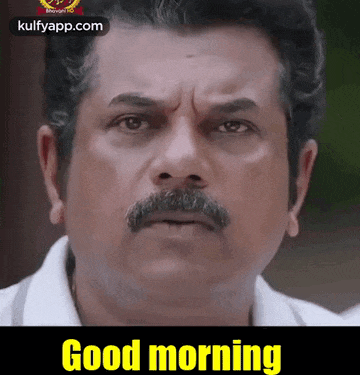 a man with a mustache is wearing a white shirt and says good morning