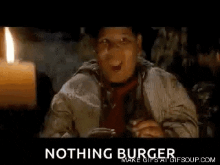 a man in a hat and tie is sitting in front of a candle and a sign that says nothing burger .